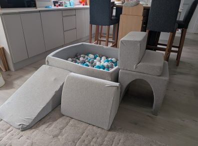 Soft foam ball pit with activity pieces