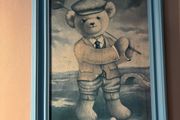 Teddy playing golf print in a blue wooden frame