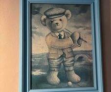 Teddy playing golf print in a blue wooden frame