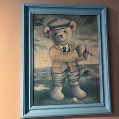 Teddy playing golf print in a blue wooden frame