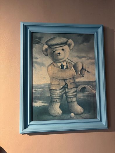 Teddy playing golf print in a blue wooden frame
