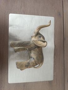 The sculpture is an antique figurine of an elephant