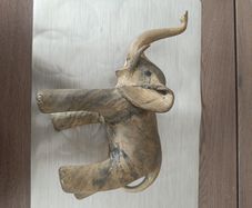 The sculpture is an antique figurine of an elephant