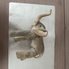 The sculpture is an antique figurine of an elephant
