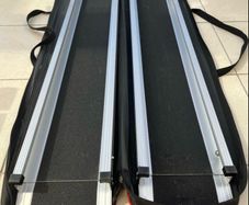 Telescopic channel ramps 7ft (213cm long) for a wheelchair with black grip surface and bag