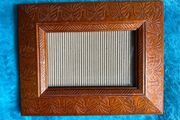 Hand-carved vintage wooden picture frame with a natural grain finish.