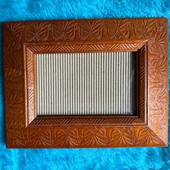 Hand-carved vintage wooden picture frame with a natural grain finish.