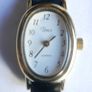 Vintage Timex womens quartz watch - gold tone oval case, white dial and black strap Image 3