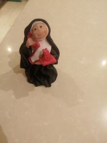 Sister folk figurine Nun on phone