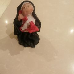 Sister folk figurine Nun on phone