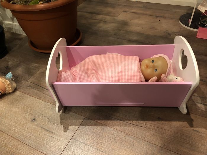 Doll crib with a baby