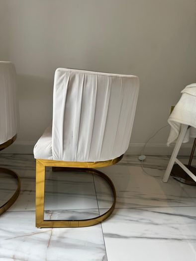 Cream and gold armchairs