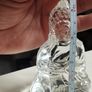 A glass Buddha figurine seated in the lotus position. Image 5