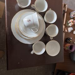 Six piece set of finebone  China, six cups, six saucers, six side plates, one larger plate and sugar bowl.