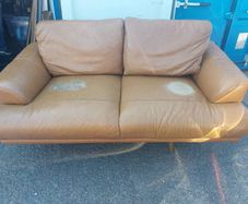 Brown leather sofa and matching foot poof