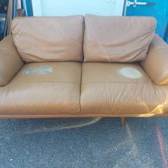 Brown leather sofa and matching foot poof