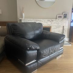 black Leather Armchair featuring plush pillow top arms and chrome accent feet need gone ASAP due to house clearance
