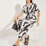 Monochrome animal print V-neck jumpsuit featuring batwing sleeves and a wide-leg cut pant leg size UK 12 Image 2