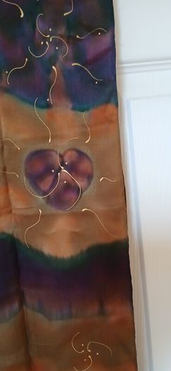 Hand painted, 100% silk scarf featuring a hand-rolled hem and custom metallic gutta detailing.