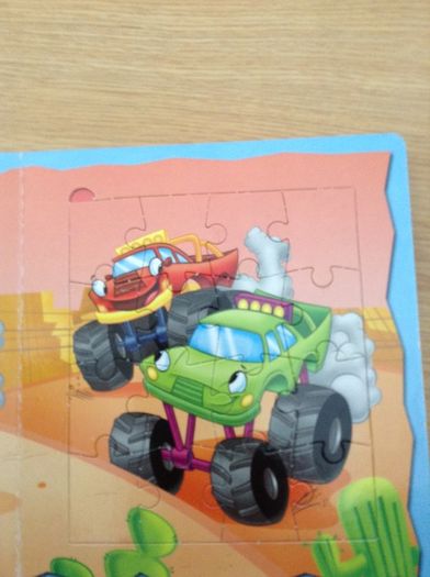 Jigsaws of racing cars in a book