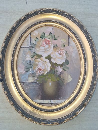 Oval oil painting depicting a still life with flowers,