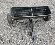 Lawn seed and fertiliser spreader