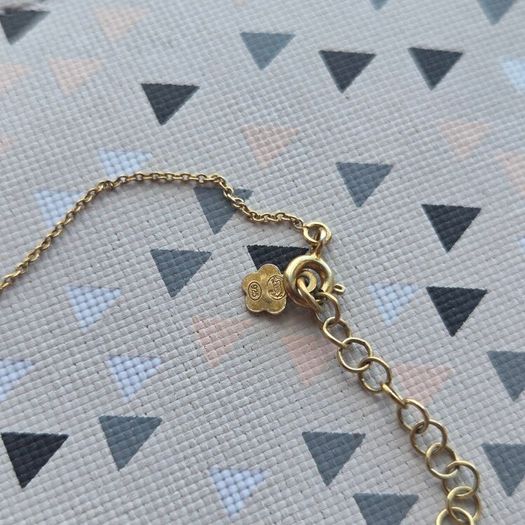 925 sterling silver bracelet with yellow gold plating and V shaped pendant.