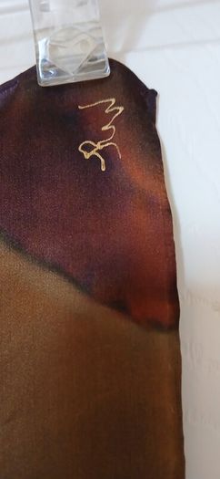 Hand painted, 100% silk scarf featuring a hand-rolled hem and custom metallic gutta detailing.