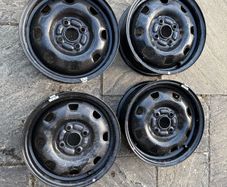 Four Black Steel Wheel Rims and Sixteen bolts