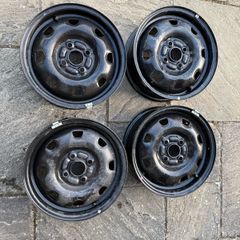 Four Black Steel Wheel Rims and Sixteen bolts