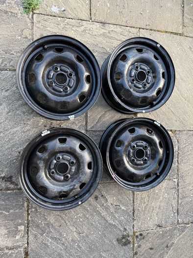 Four Black Steel Wheel Rims and Sixteen bolts