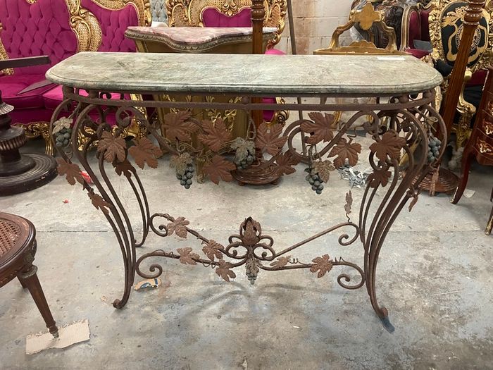 This old console table is handmade wrought iron