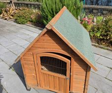 Wooden pet house with green felt roof