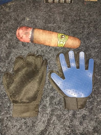 A pair of pet grooming and deshedding glove and Cigar designed toy for dogs