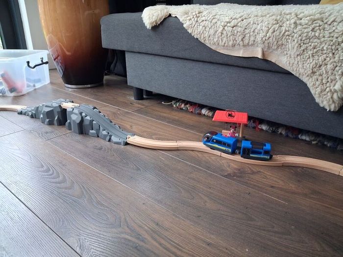 wooden train track set with wooden trains and accessories.