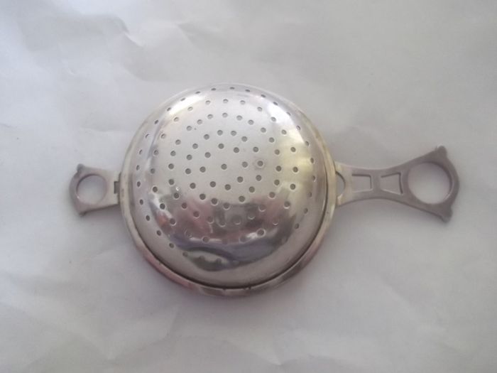 a solid  vintage silver strainer