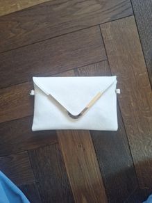 Beige clutch with gold accents