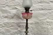 Early Edwardian oil lamp with cast metal base.