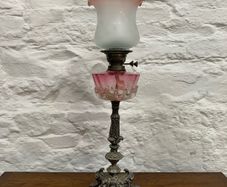 Early Edwardian oil lamp with cast metal base.
