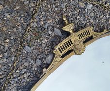 Antique oval overmantle with brass surround