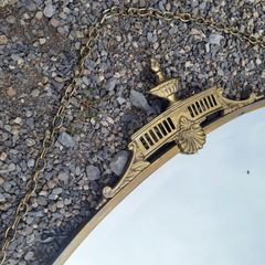 Antique oval overmantle with brass surround