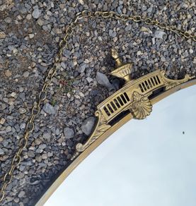 Antique oval overmantle with brass surround
