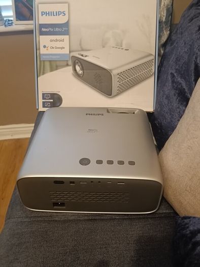 philips neopix ultra 2tv+ home projector and height adjustable stand, built in speakers and android TV with play store stand comes with power point bracket on it as seen in pictures also remote and phone holder