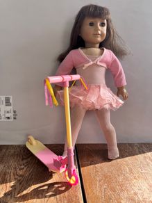 American Girl doll with OG toy scooter