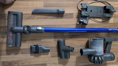 Dyson V6 handheld vacuum cleaner with charger and accessories