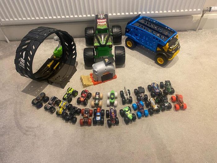 Hot Wheels Monster Trucks collection with transporter and track