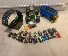 Hot Wheels Monster Trucks collection with transporter and track