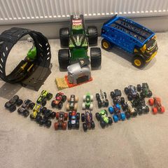 Hot Wheels Monster Trucks collection with transporter and track