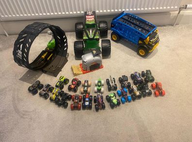 Hot Wheels Monster Trucks collection with transporter and track