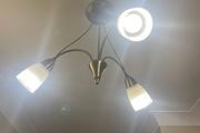 Semi-flush antique brass ceiling  light fitting with 3 frosted glass shades.